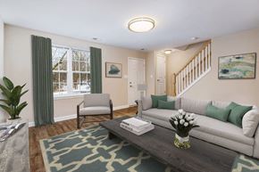 Damascus townhouse for rent - A living room with a grey couch, a coffee table, and a plant.