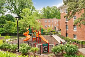 Silver Spring apartment for rent - A playground with a slide and a green fence.