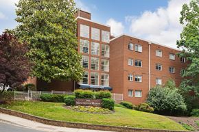 Silver Spring apartment for rent - A red brick building with a sign that says "Manchester Meadows".
