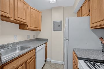 Silver Spring apartment for rent - A kitchen with wooden cabinets and a white refrigerator.