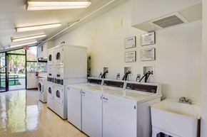 Derwood townhouse for rent - A laundromat with a row of washers and dryers.