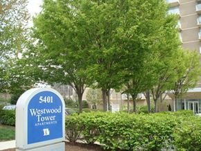 Bethesda apartment for rent - A sign for Westwood Tower Apartments stands in front of a building and trees.
