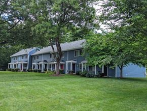 Gaithersburg townhouse for rent - A large house with a red door and a tree in front.
