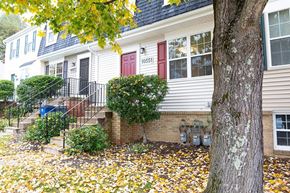 Damascus townhouse for rent - A house with a red door and a tree in front.