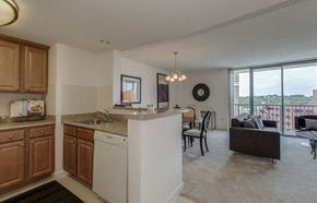 Bethesda apartment for rent - A kitchen with wooden cabinets and a white dishwasher.