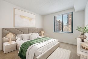 Bethesda apartment for rent - A bedroom with a large bed and a painting on the wall.