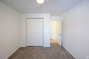 Bedford Heights apartment for rent - A bedroom with a white wardrobe and carpeted floor.