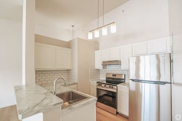Wadsworth apartment for rent - A kitchen with a marble countertop and stainless steel appliances.