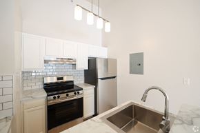 Wadsworth apartment for rent - A kitchen with a stove, refrigerator, and sink.