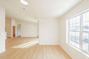 Wadsworth apartment for rent - A large empty room with wooden floors and a window overlooking a snowy landscape.