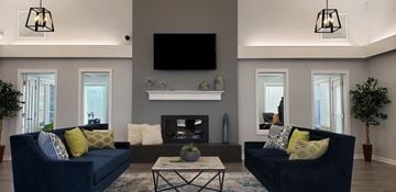 Groveport apartment for rent - a living room with blue couches and a fireplace