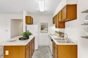 Groveport apartment for rent - A kitchen with wooden cabinets and a white refrigerator.