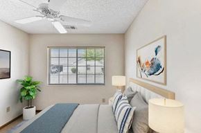 Groveport apartment for rent - A bedroom with a bed, a ceiling fan, and a window with blinds.