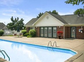 Groveport apartment for rent - A pool in front of a house with a white picket fence.