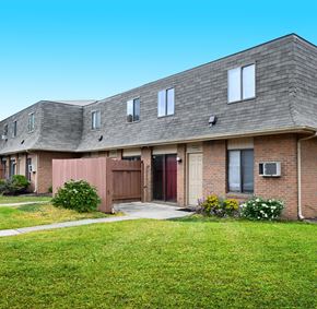 Columbus apartment for rent - the front of a brick house with a yard and grass