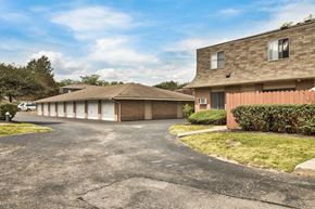 Columbus apartment for rent - a parking lot in front of a house with a car garage