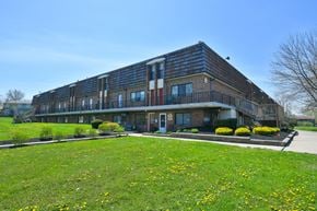 Medina apartment for rent - a large brick building with a green lawn in front of it