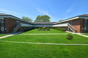 Medina apartment for rent - a courtyard in front of a building with green grass