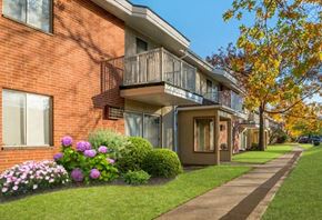 Bedford Heights apartment for rent - a brick apartment building with a balcony and a sidewalk