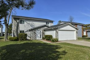 Lorain apartment for rent - a white house with a white garage door and a lawn