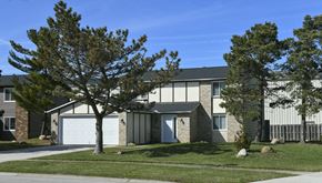 Lorain apartment for rent - a house with a lawn and trees in front of it