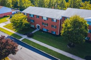 Garfield Heights apartment for rent - an aerial view of a brick building with green grass and trees