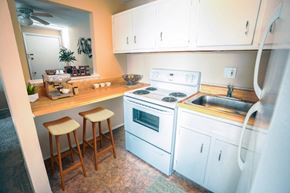 Garfield Heights apartment for rent - a kitchen with white appliances and a counter with two stools