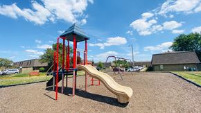 Columbus apartment for rent - A playground with a red and blue structure and a yellow slide.