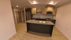 Dartmouth apartment for rent - A kitchen with a refrigerator, microwave, and oven.