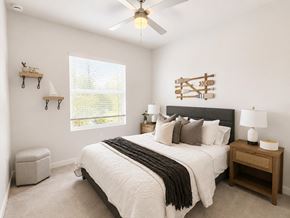 Fort Pierce apartment for rent - A bedroom with a large bed and a ceiling fan.