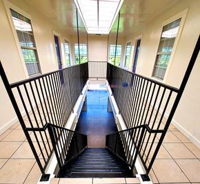 Denton apartment for rent - a view down the stairs of a building with windows