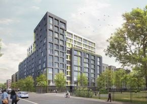 Bronx apartment for rent - A modern building with a glass facade is surrounded by trees and people are walking around.