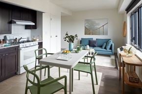 Bronx apartment for rent - A modern kitchen with a dining table and chairs.