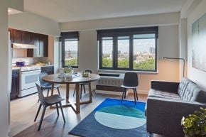 Bronx apartment for rent - A modern kitchen with a dining table and chairs.