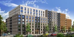 Bronx apartment for rent - A modern multi-story building with a mix of dark and light colored windows.