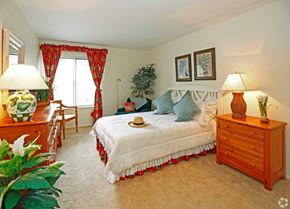 Farmington Hills apartment for rent - a bedroom with a bed and a dresser and a window