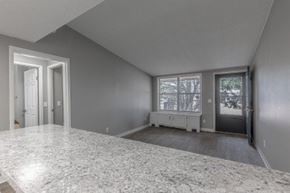 Newburgh apartment for rent - A spacious room with a marble floor and a window with blinds.