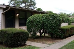 Newburgh apartment for rent - A house with a green hedge in front.