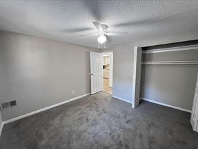 Newnan apartment for rent - A room with a grey carpet and a white ceiling fan