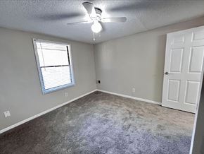 Newnan apartment for rent - A room with a ceiling fan and a window with blinds