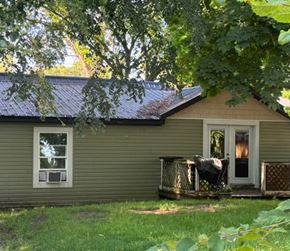 Belding house for rent - a house with a metal roof and a deck