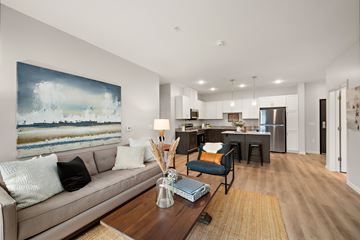 Rosemount apartment for rent - A modern living room with a large painting on the wall and a beige sofa.