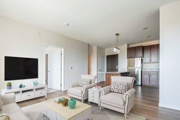 Brooklyn Center apartment for rent - a living room with white furniture and a tv
