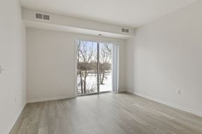 Eagan apartment for rent - A spacious room with a sliding glass door leading to a snowy landscape.