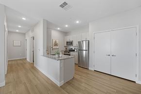 Casa Grande apartment for rent - A kitchen with white cabinets and a wooden floor.