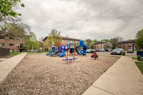 St Paul apartment for rent - a playground in a park in front of a building at Ames Lake Neighborhood Apartments, Minnesota