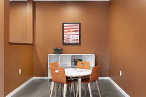 Eagan apartment for rent - A dining room with a white table and orange chairs.