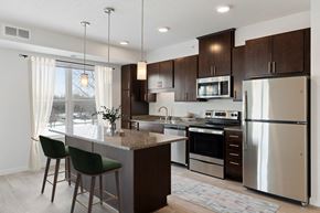 Eagan apartment for rent - a kitchen with stainless steel appliances and a marble counter top