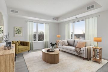 Eagan apartment for rent - A living room with a yellow chair and a white couch.