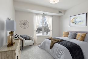 Eagan apartment for rent - an example of a bedroom with a bed and a window